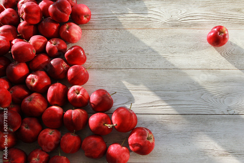 Red apples on white wooden boards or desk. Background, copy space, top view. Autumn, fall, harvest, apple picking concept