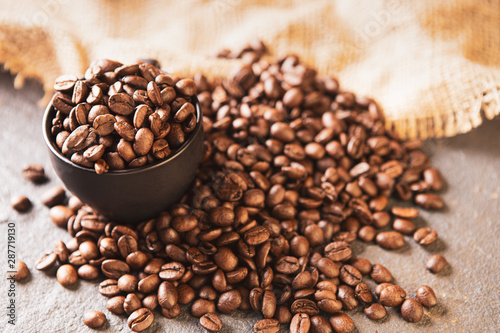Coffee beans. Coffee cup full of coffee beans. Toned image
