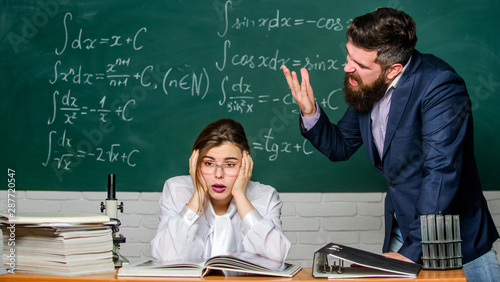 Man unhappy communicating. Conflict situation. School conflict. Demanding lecturer. School principal talking about punishment. Teacher strict serious bearded man having conflict with student girl