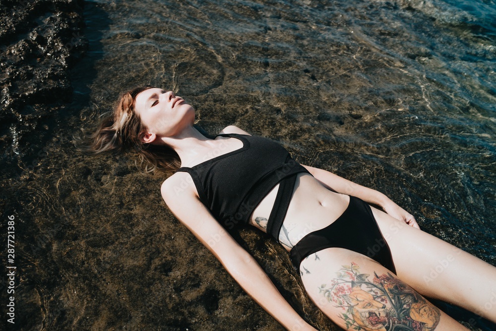Attractive young model posing on rock Attractive young model posing on rock