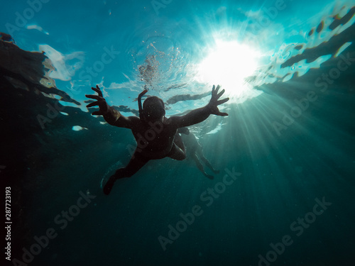 Underwater photo of men snorkeling in a sea