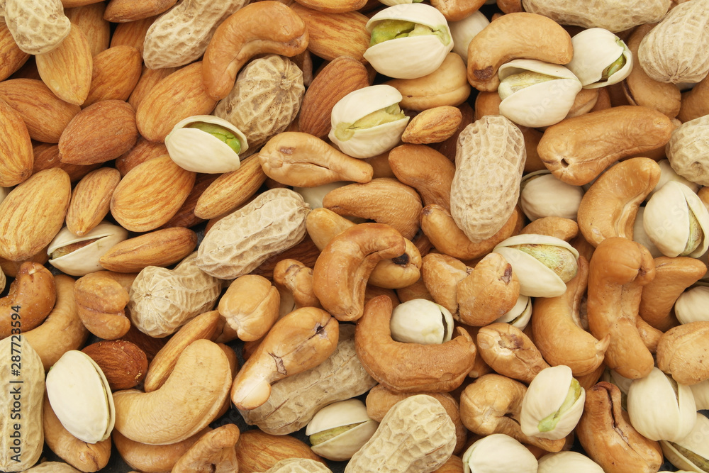 Mixed nuts background, almonds, pistachios, cashews and peanuts Mixed nuts background, almonds, pistachios, cashews and peanuts