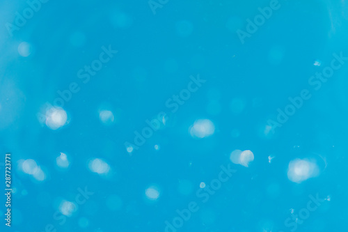 abstract background in blue colors light reflected in water looks weird with air bubbles and bokeh with blur