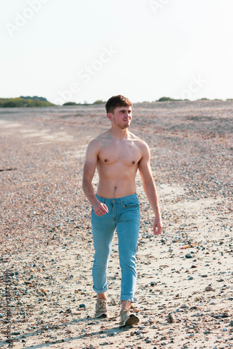Shirtless on a beach © Ben Gingell