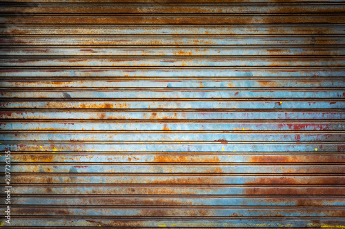 Old weathered and rusty steel door for steel metal backgroud and texture.