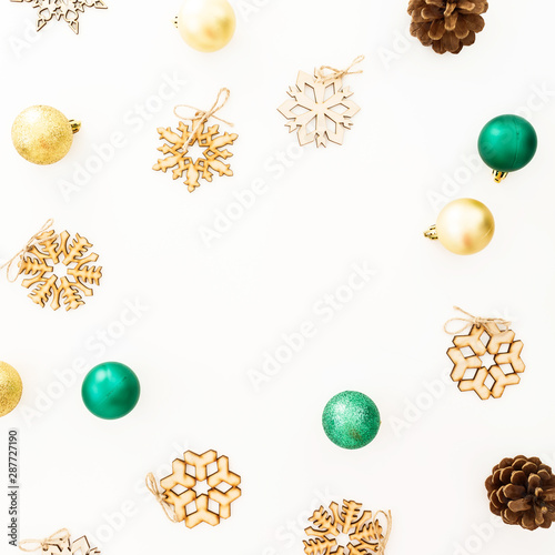Holiday frame with Christmas balls and snowflake decorations on white background. Flat lay, top view