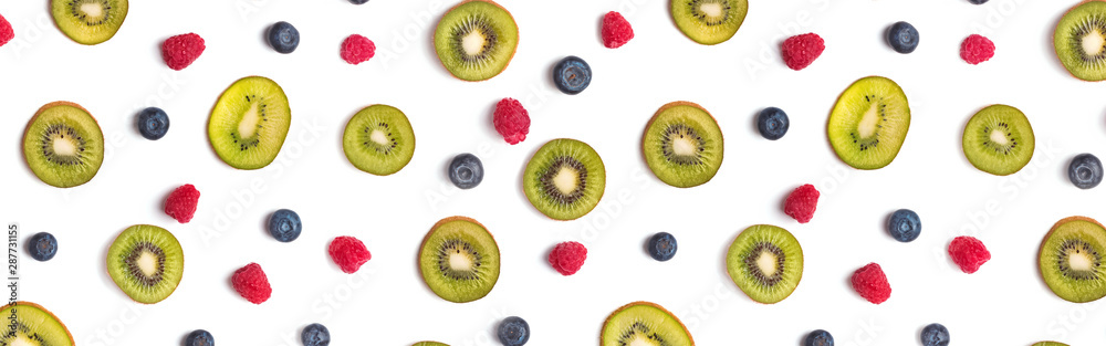 Fototapeta premium Creative fruit banner. Kiwis, blueberries and raspberries on the white background