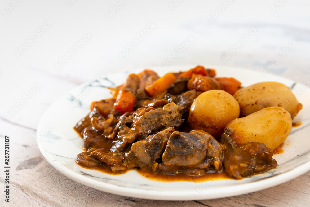 Beef meat stewed with potatoes-Traditional French cuisine Beef Bourguignon potatoes carrots in persillade Beef meat stewed with potatoes-Traditional French cuisine Beef Bourguignon potatoes carrots in persillade