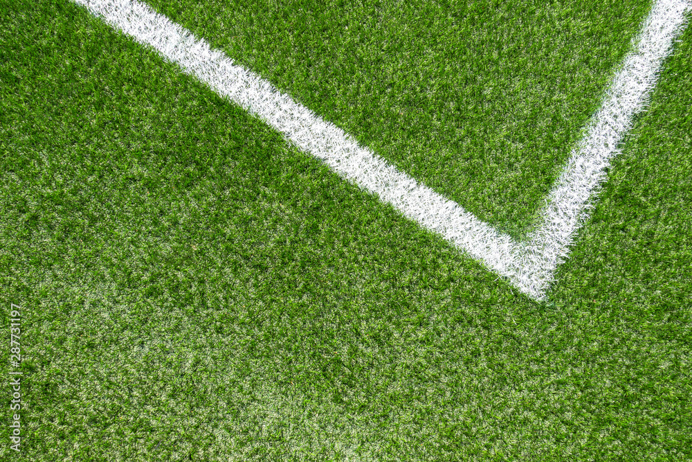 Green synthetic grass soccer sports field with white corner stripe line