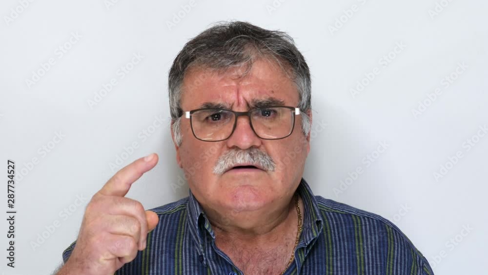 Senior man (50s-60s) waving finger to refuse isolated on white background. Senior man (50s-60s) waving finger to refuse isolated on white background.