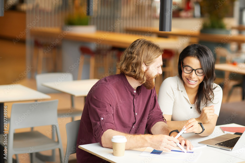 Young business people have a meeting in cafe they sitting at the table and discussing new business project in team Young business people have a meeting in cafe they sitting at the table and discussing new business project in team