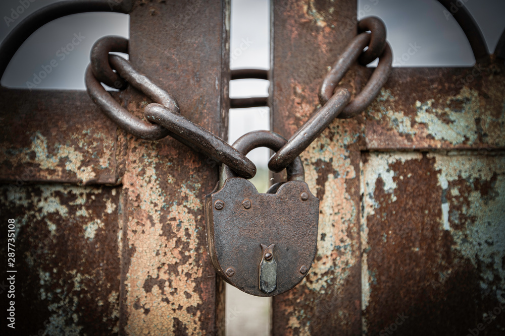 Close up of old metal lock and chain on the ground. Close up of old metal lock and chain on the ground.