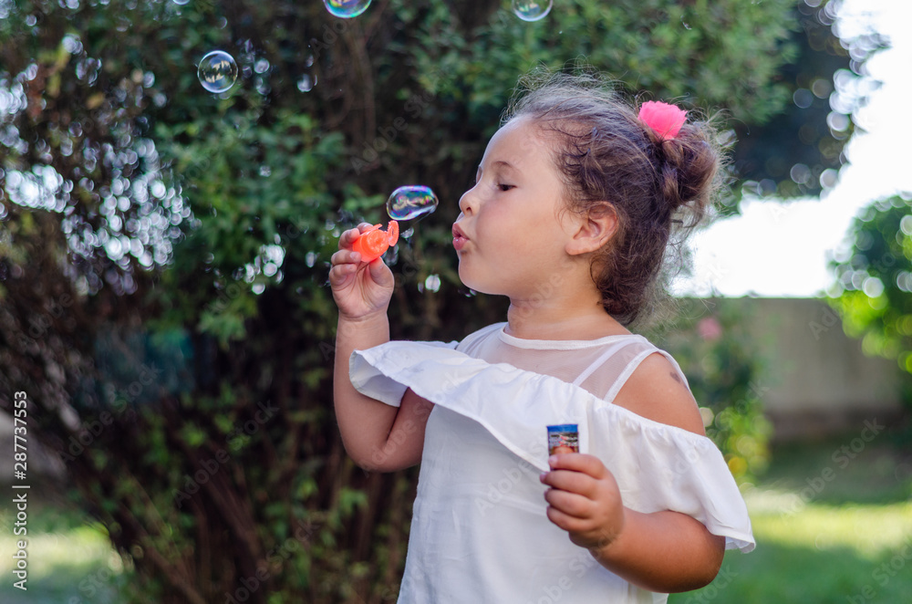 Cute girl blowing soap bubbles Cute girl blowing soap bubbles