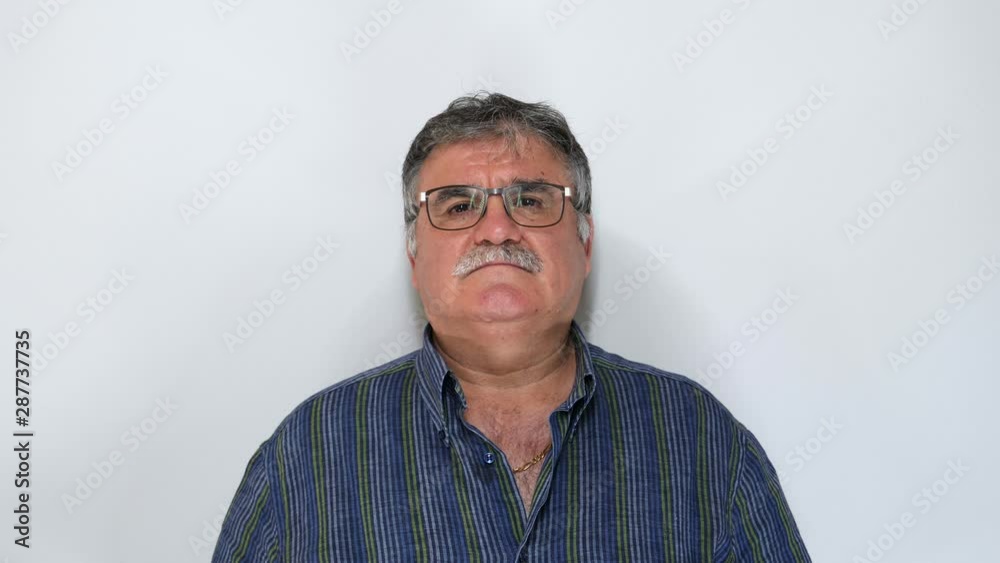 Senior man with glasses looking at camera isolated on white background. Shot In 4K Senior man with glasses looking at camera isolated on white background. Shot In 4K
