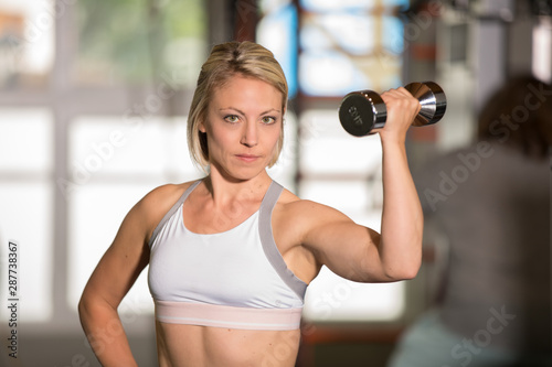 Woman fitness workout with dumbbell