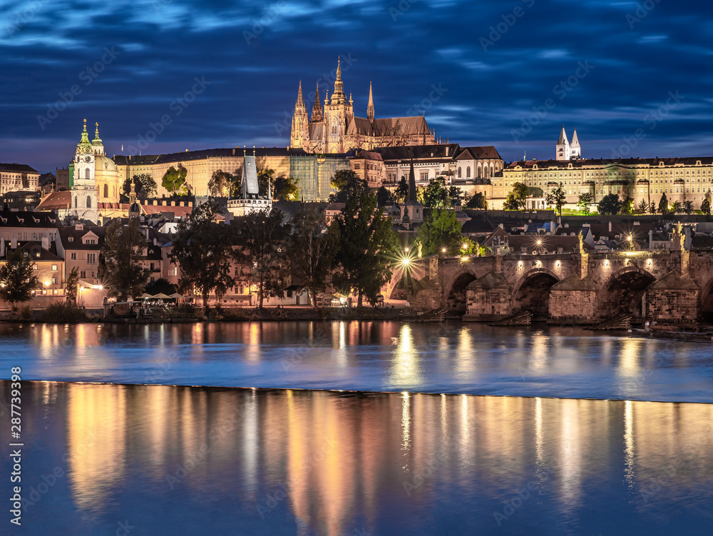 Prague - Czech Republic - Sunset or sunrise view of Charles Bridge and Prague Castle over Vltava river and historical center of Prague, buildings and landmarks of old town 