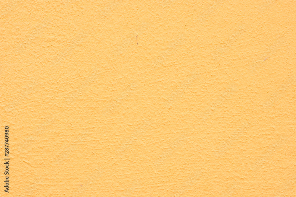 Background of a yellow stucco coated and painted exterior, rough cast of cement and concrete wall texture Background of a yellow stucco coated and painted exterior, rough cast of cement and concrete wall texture