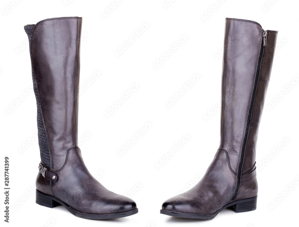 Classic brown glossy leather high knee flat heels female boots. Two isolated Classic brown glossy leather high knee flat heels female boots. Two isolated