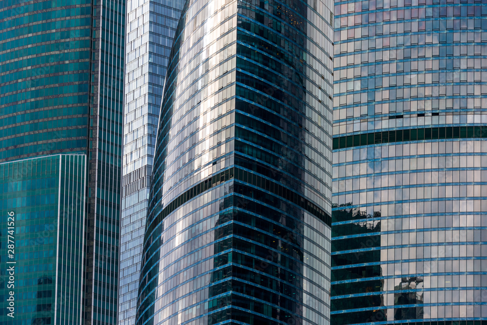 The glass facade of downtown Skyscrapers gleams in the sun. The glass facade of downtown Skyscrapers gleams in the sun.