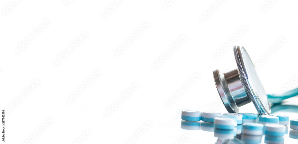 Stethoscope and pills on white banner background with copy space, medical concept Stethoscope and pills on white banner background with copy space, medical concept
