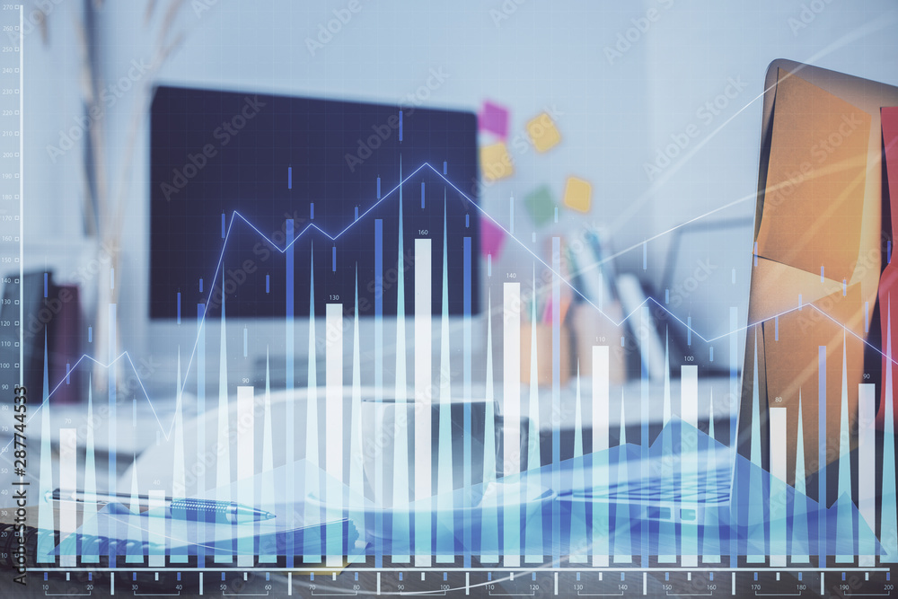 Stock market chart hologram drawn on personal computer background. Multi exposure. Concept of investment. Stock market chart hologram drawn on personal computer background. Multi exposure. Concept of investment.