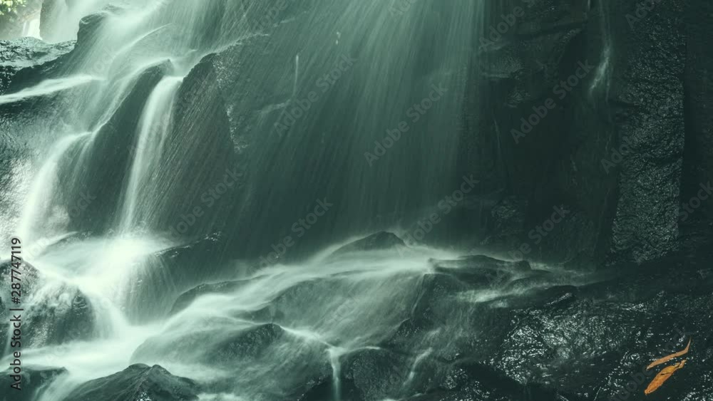 Scenic Kanto Lampo waterfall cascading down a stepped rock in Bali island Indonesia. Timelapse 4K
