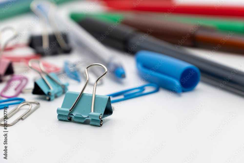 Colorful office tools set, pen, binder, paper clip, pencils, eraser isolated on white background Colorful office tools set, pen, binder, paper clip, pencils, eraser isolated on white background