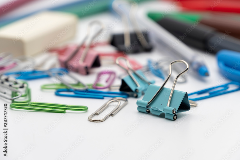 Colorful office tools set, pen, binder, paper clip, pencils, eraser isolated on white background Colorful office tools set, pen, binder, paper clip, pencils, eraser isolated on white background