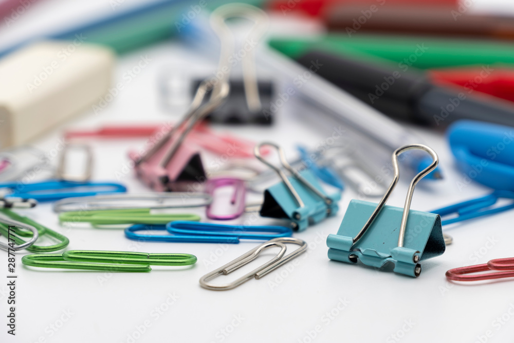 Colorful office tools set, pen, binder, paper clip, pencils, eraser isolated on white background Colorful office tools set, pen, binder, paper clip, pencils, eraser isolated on white background