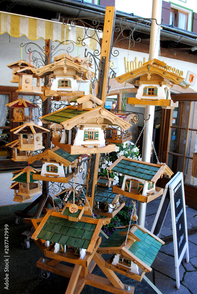 Souvenir shop in Germany, Bavaria. Beautiful wooden houses for birds, for  decorating the garden and home. Souvenirs in the national style. Stock  Photo | Adobe Stock