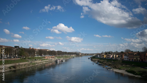 View from the covered bridge of Pavia - View on river with blue and cloudy sky