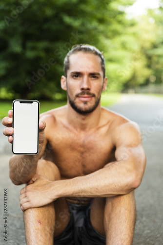 Medium shot of man holding phone mock-up