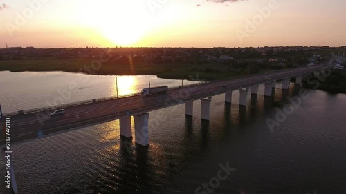 Wallpaper Mural Aerial shot of a big bridge with a riding semi-trailer at golden sunset in summer Torontodigital.ca