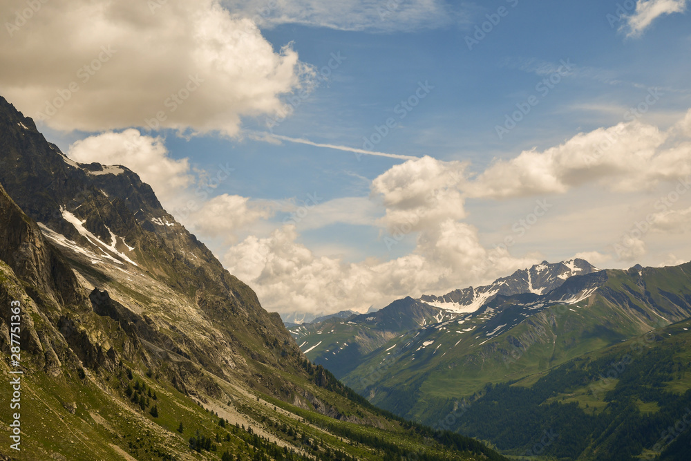 Scenic view of mountain peaks of the Mont Blanc massif in the Italian Alps in summer, Courmayeur, Aosta Valley, Italy Scenic view of mountain peaks of the Mont Blanc massif in the Italian Alps in summer, Courmayeur, Aosta Valley, Italy