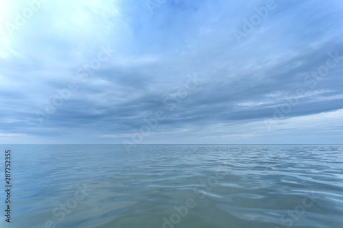 sea surface to the horizon under a cloudy sky