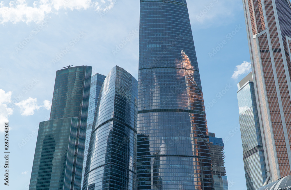 High rise buildings of the business center of Moscow. District Moscow-city against the day sky with clouds