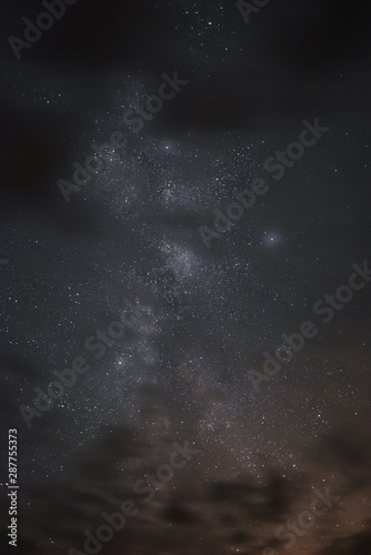 Milky way in the night sky through the clouds on a summer night © dmitriydanilov62