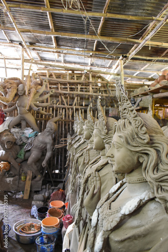 Clay idol of Goddess Devi Durga is in preparation for the upcoming Durga Puja festival at a pottery studio in Krishnanagar, West Bengal, India. photo