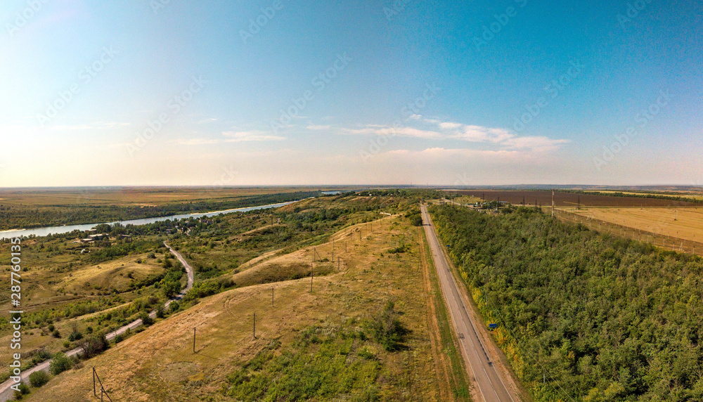 rural landscape with a road and a river. Aerial view (drone view) on a summer day in August above the right bank of the Don River near the place 