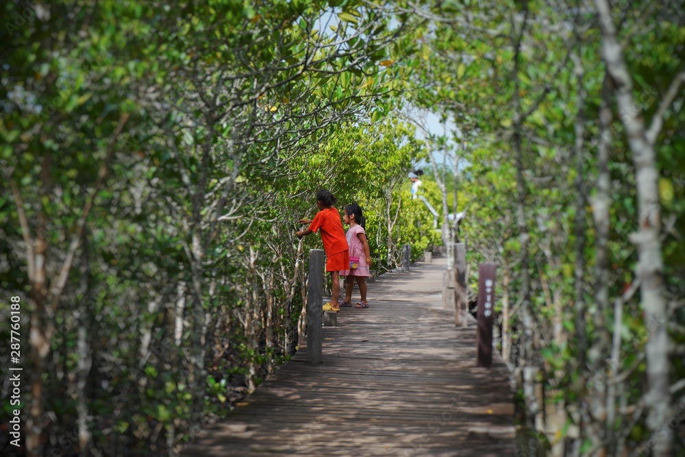 woman walking on bridge in park