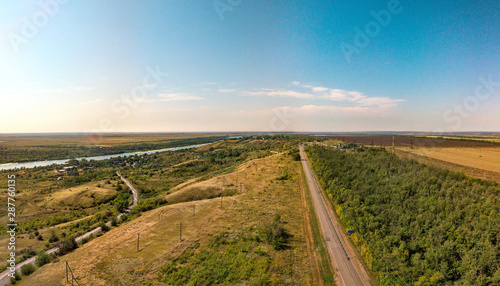 rural landscape with a road and a river. Aerial view (drone view) on a summer day in August above the right bank of the Don River near the place "Melikhovsky Turn". Shakhty-Tsimlyansk highway