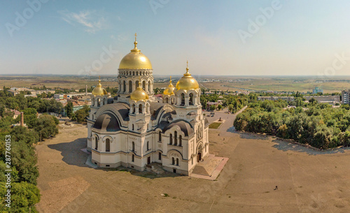 The Golden-domed Ascension Cathedral on Yermak Square in the provincial town of Novocherkassk in southern Russia. Luxurious aerial view on a sunny summer day mid-August.