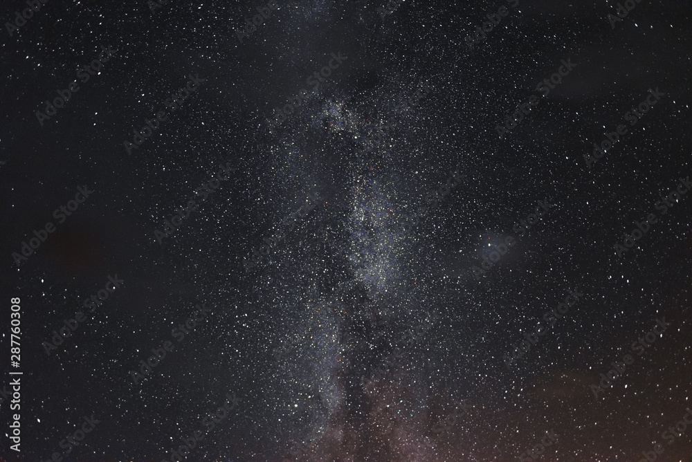 Obraz premium Milky way in the night sky through the clouds on a summer night