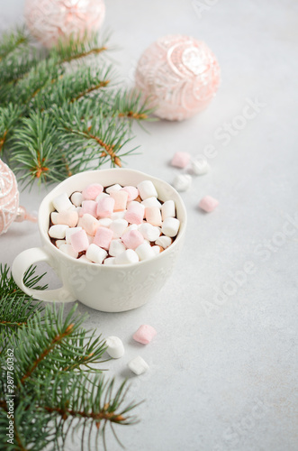Cup of hot chocolate with marshmallows on a gray concrete background. Christmas concept.