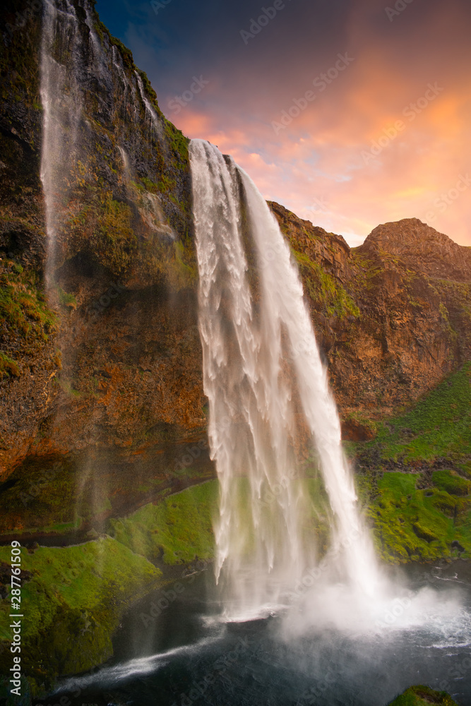 Waterlall Seljalandsfoss at the sunset.