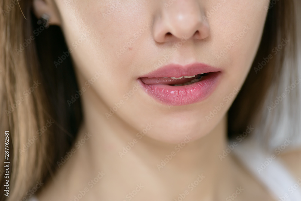Beautiful female lips, close up. Selective focus. Beautiful female lips, close up. Selective focus.