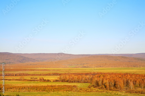 Scenic autumn landscape. meadow, forest and mountains. natural background.