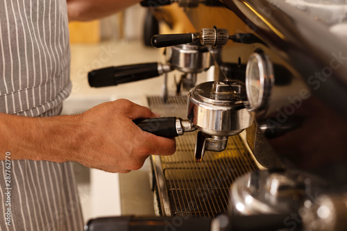 Close up of barista making coffee for clients in the morning