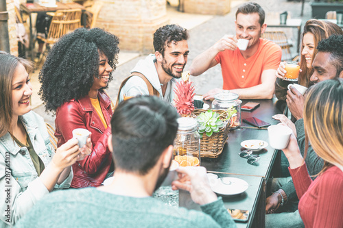 Obraz na plátně Group of young millennials people having breakfast together drinking coffe and cappuccino together