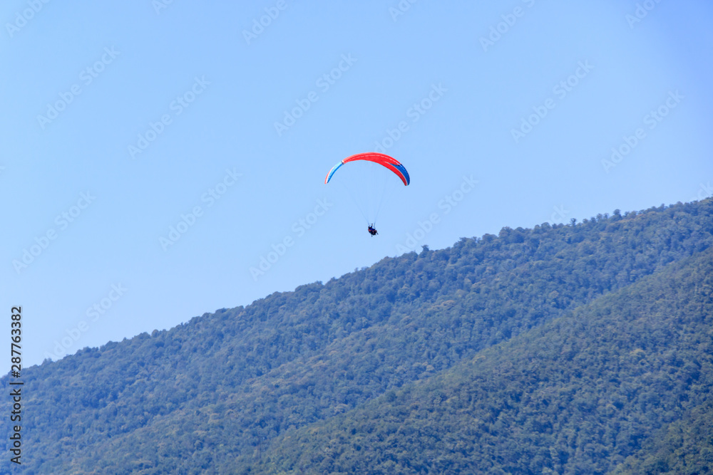 flight with an instructor on a paraglider over the mountains. flight with an instructor on a paraglider over the mountains.